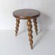 old tripod stool plant holder in turned wood