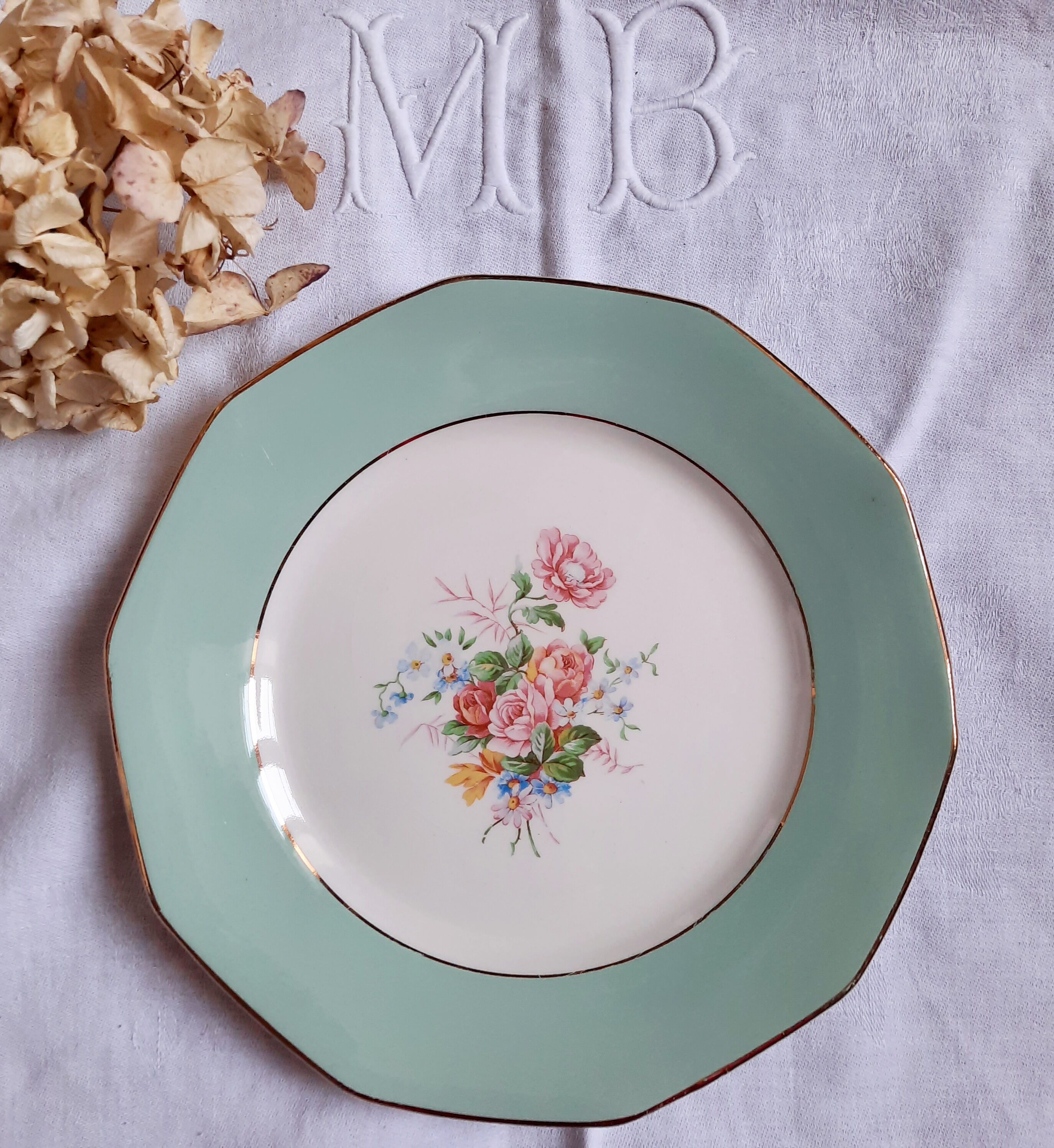 Flat antique earthenware plates with gilded edges