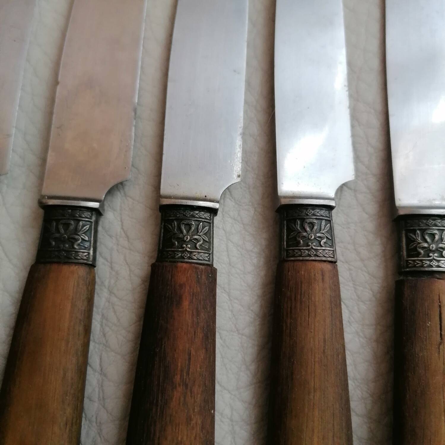 Old table knives and dessert knives, wooden handles, stainless steel blades
