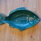 Ceramic serving flat plate in the shape of green fish