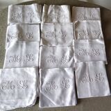 12 large antique damask towels with floral decoration and embroidered with the ML monogram