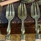 Dessert forks in brass and Bakelite in their case.