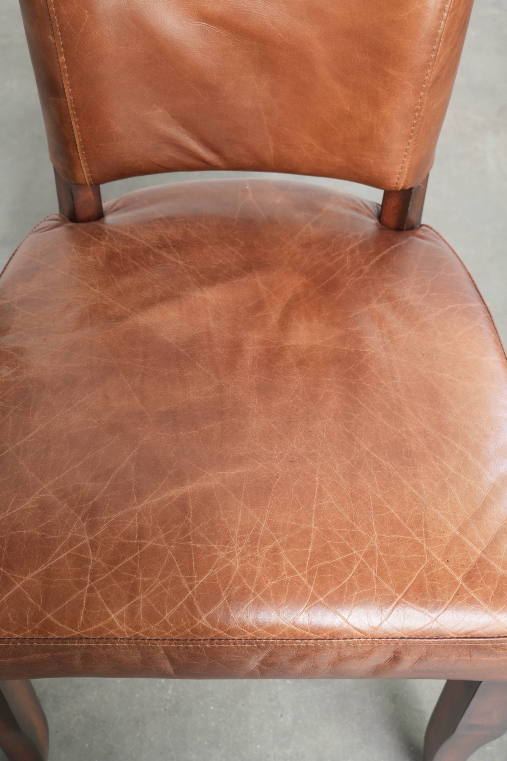 Set of 4 cognac-coloured cowleather dining chairs with decorative nails