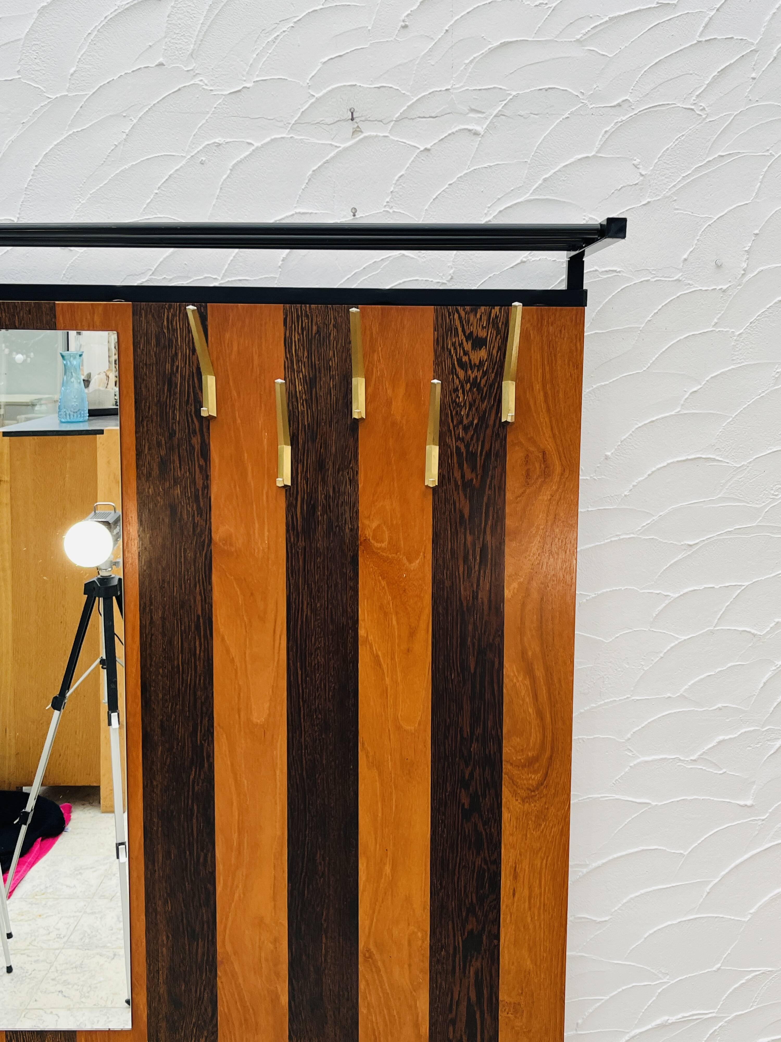 Vintage wall coat rack with storage bench from the 1970s.