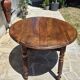 Round dining table with a drop-leaf top in solid walnut, late 19th century.