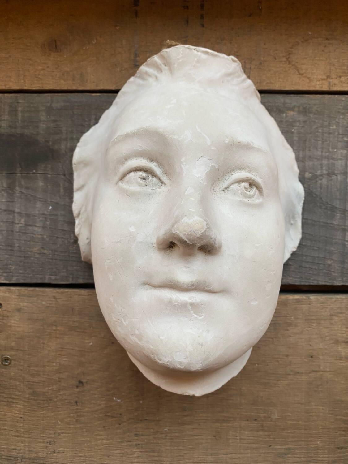 Plaster face wall statue