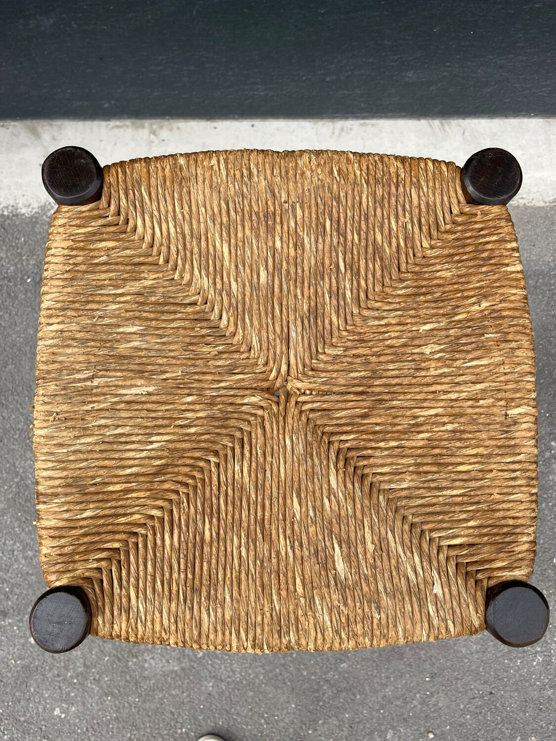 Old high bar stool in wood and straw