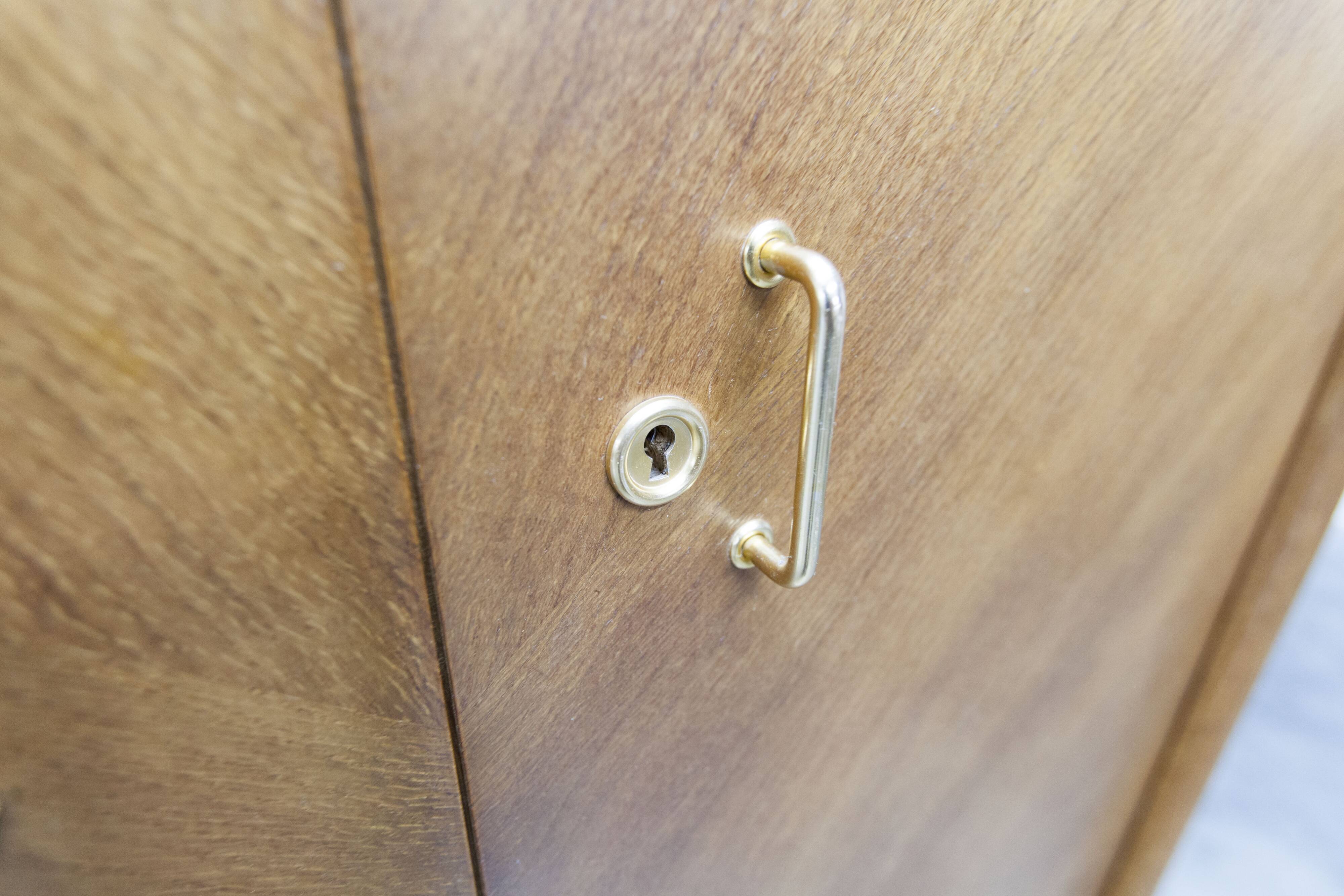 1950s Mid-Century Modern oak armoire with two doors and two drawers.