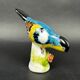 Figurine porcelaine oiseau polychrome sur socle fleuri vintage