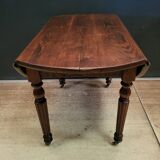 Old round table with folding shutters on casters in solid wood in very good condition