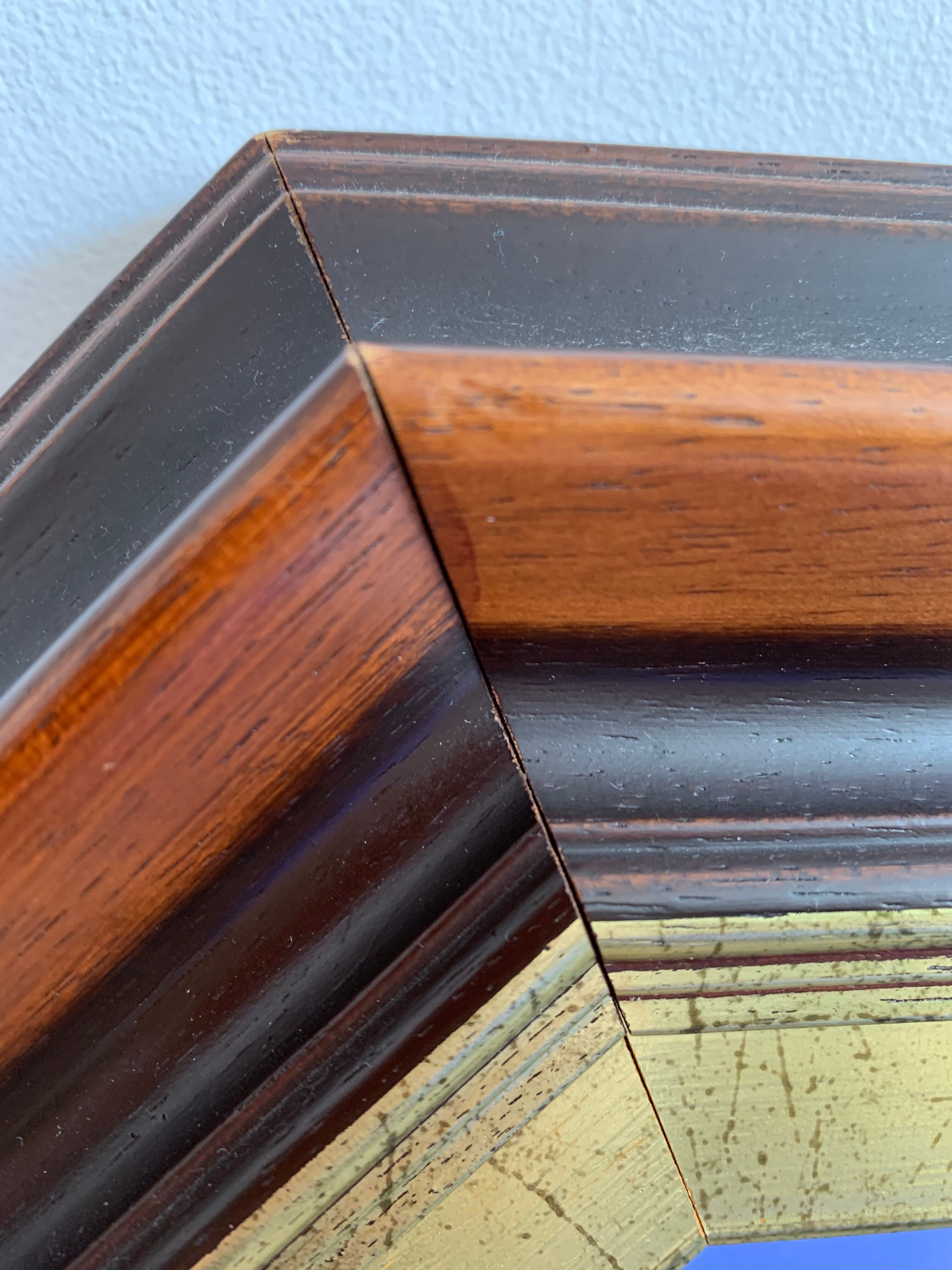 Beveled hexagonal mirror with cut wooden sides, gilded edging decoration