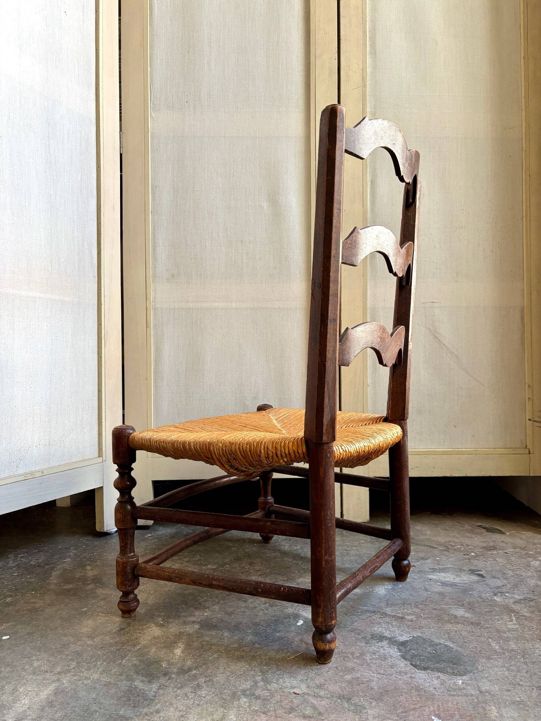 Low Provencal chair in dark wood and woven straw