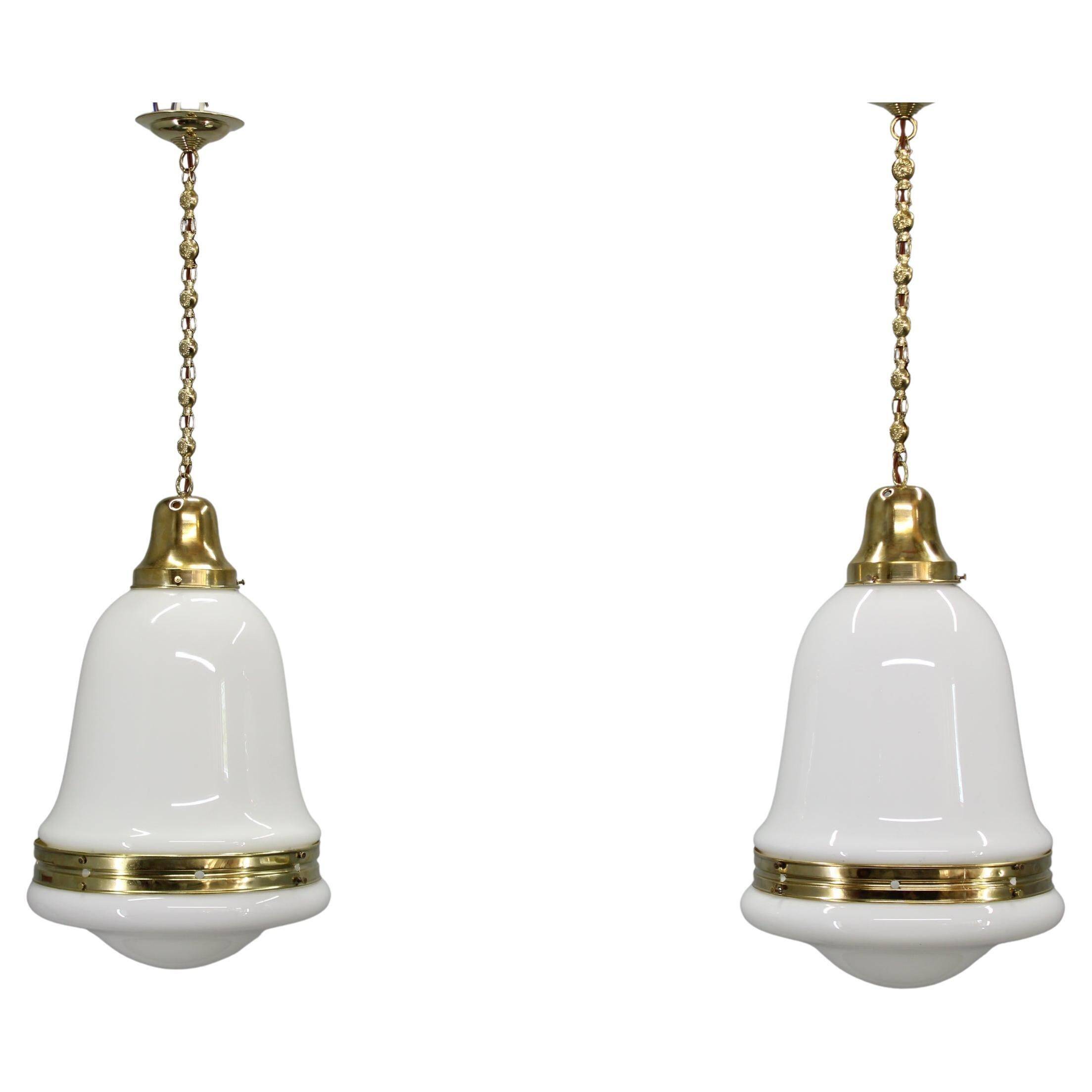 Pair of 1930s Peter Behrens Luzette pendants in opaline glass and brass