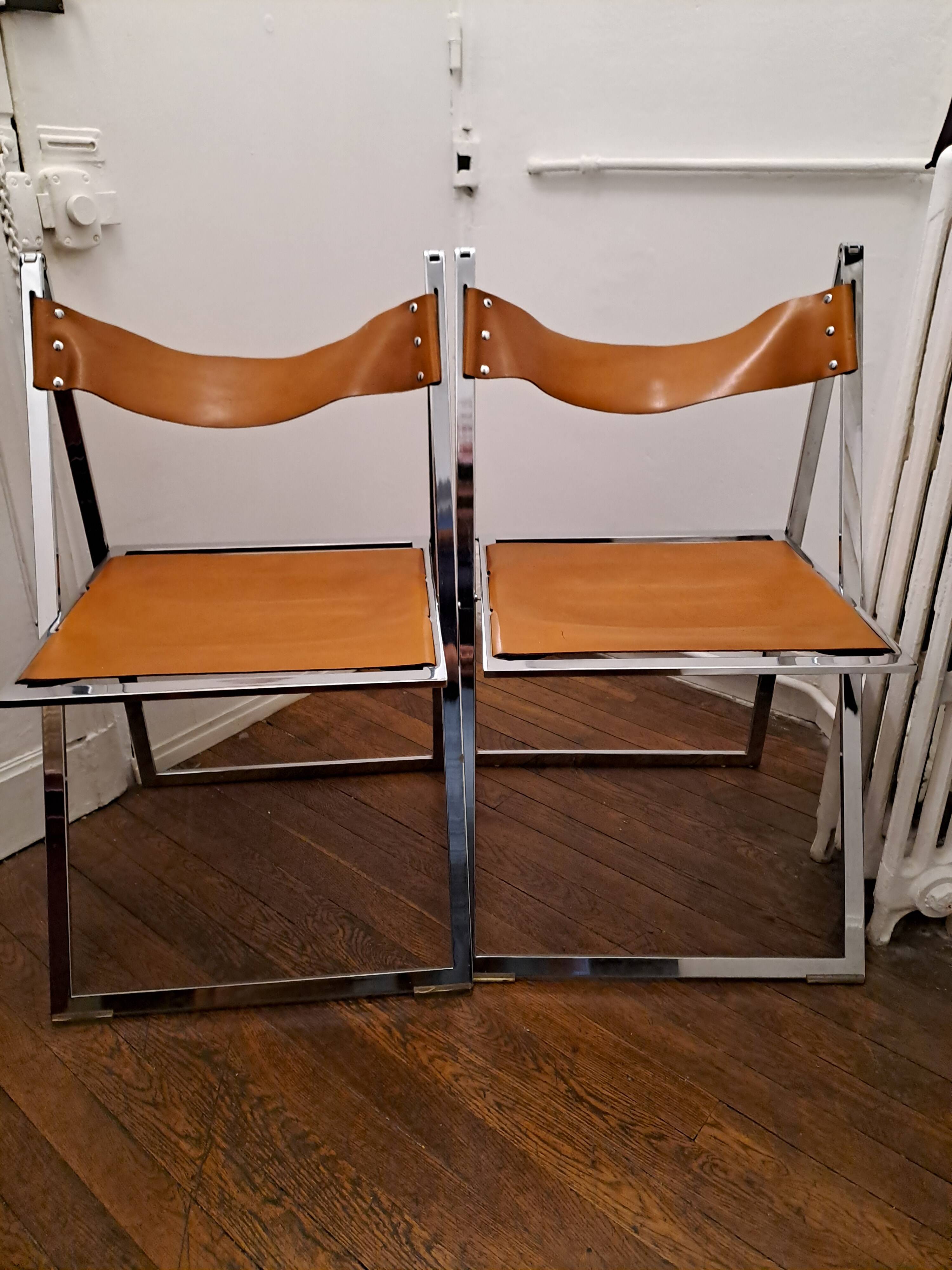 2 Chromed metal and leather folding chairs. 70s. Fontoni & Geraci