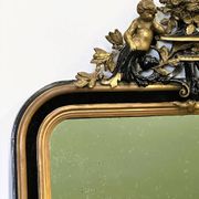 Antique 1800s black and gold mirror with cupid, France 1800s.