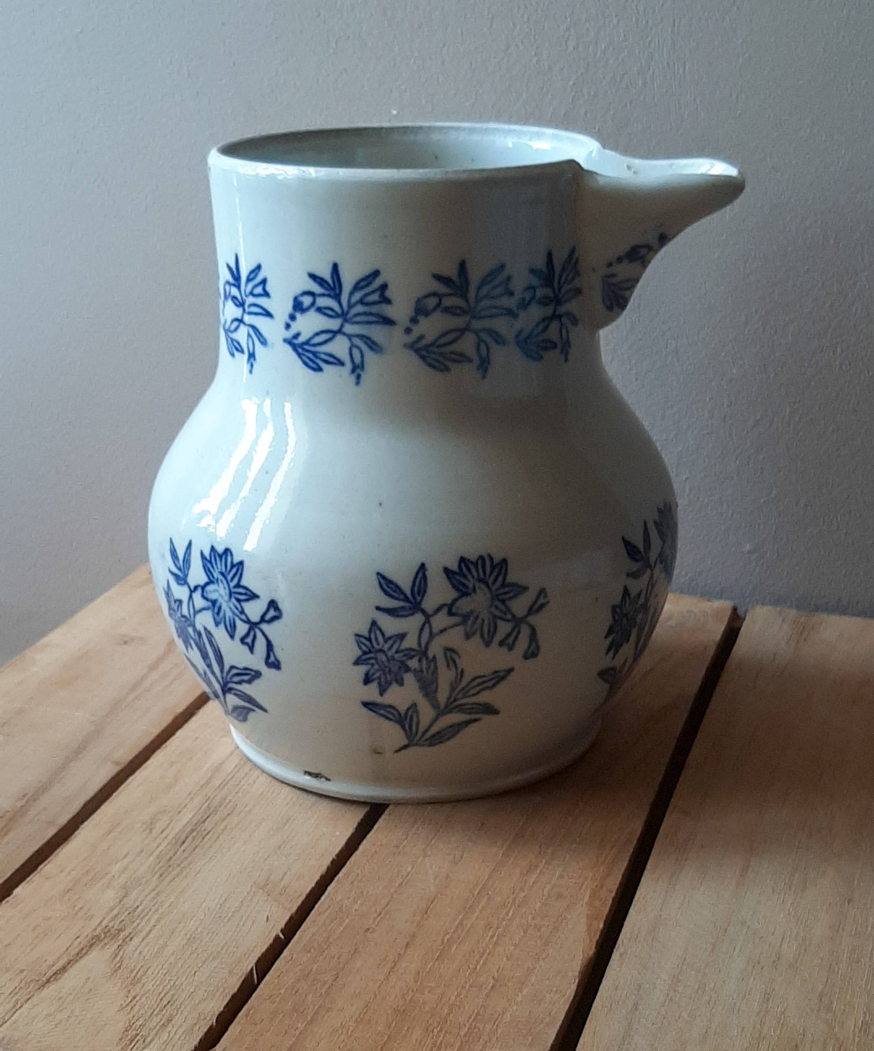 Large antique cruet in Saint Uze earthenware with blue flowers.