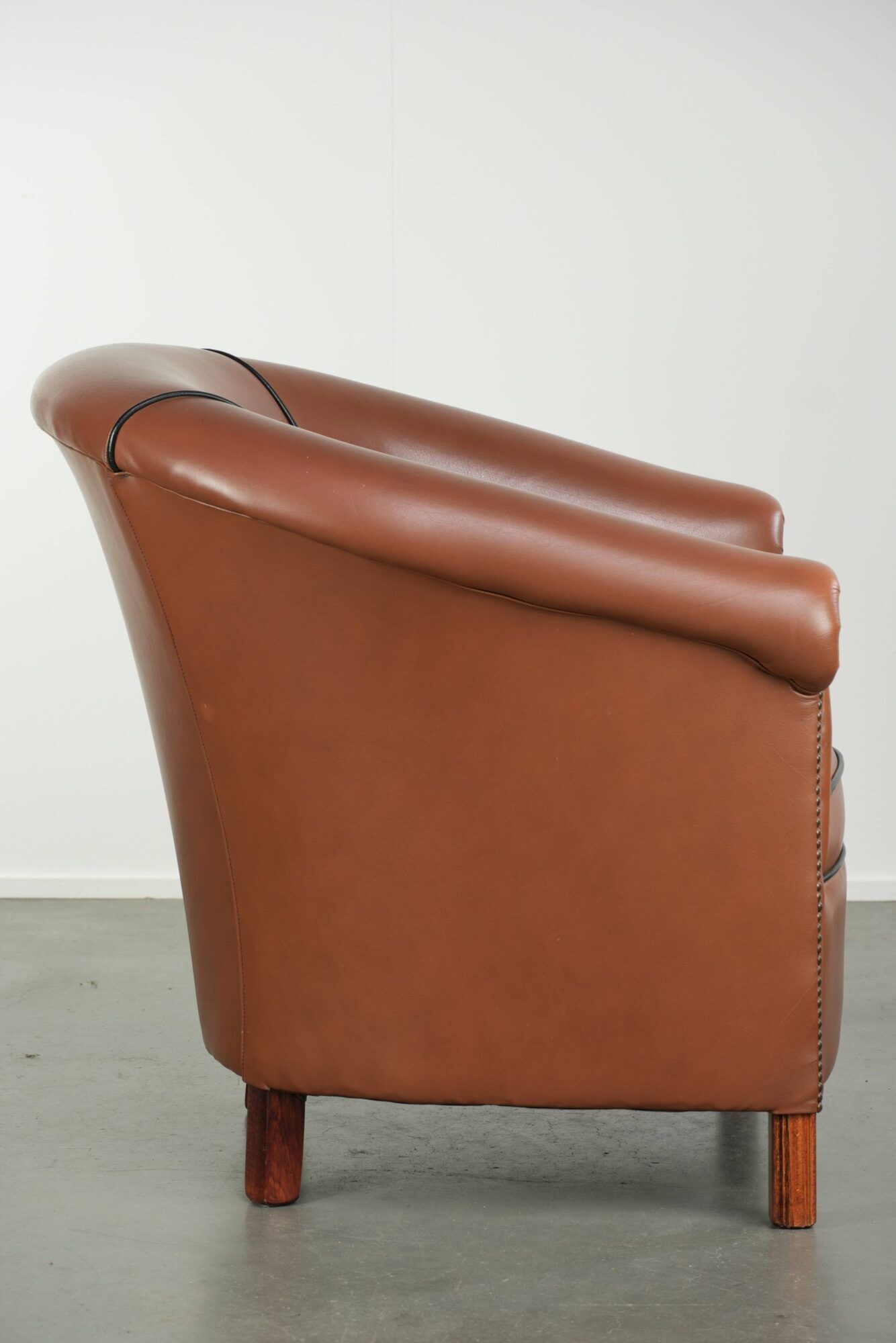 Cowhide club armchair in English style with comfortable seating.