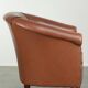 Cowhide club armchair in English style with comfortable seating.