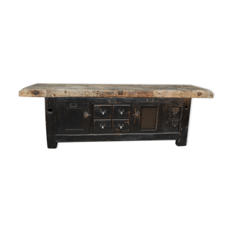 Former 1930 carpenter's workbench has black patinated doors and drawers
