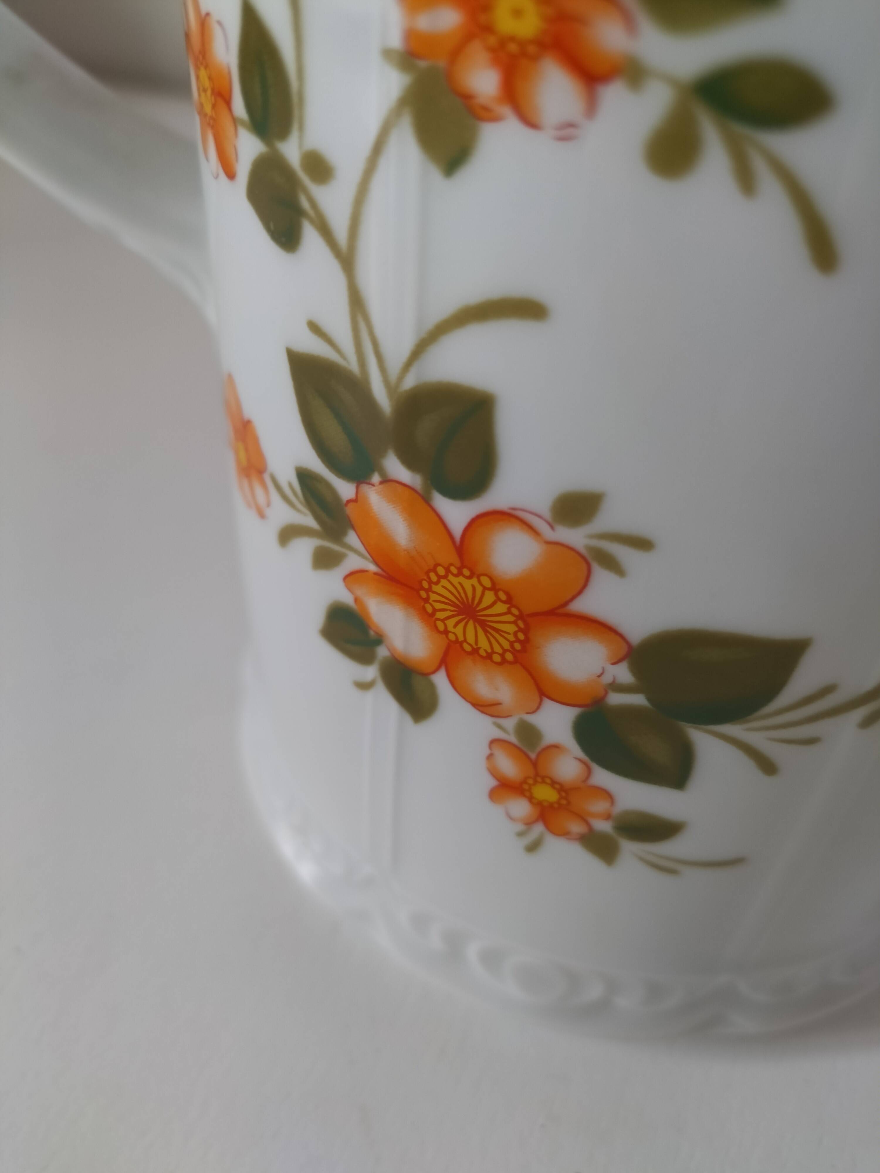 Vintage coffee pot Winterling Bavaria with orange floral decoration.