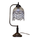 Retro brass lamp with a glass shade and bead fringes.
