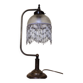 Retro brass lamp with a glass shade and bead fringes.