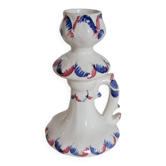 Ceramic candlestick with red and blue decoration.