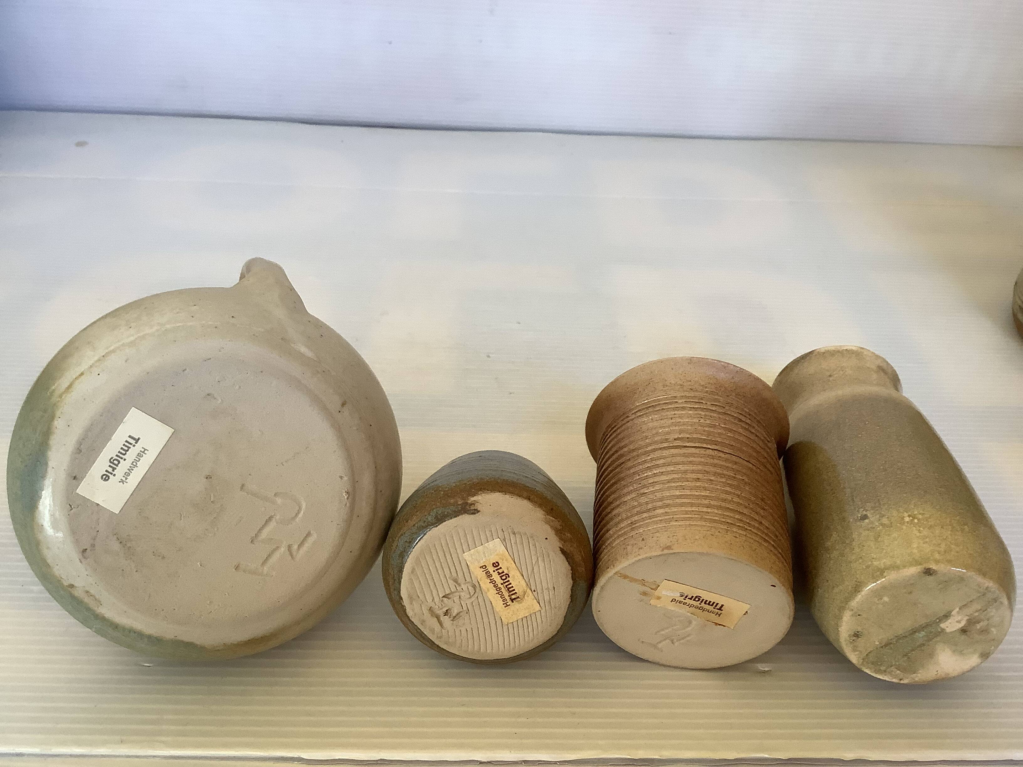 Seven beige and gray ceramic vases