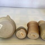 Seven beige and gray ceramic vases