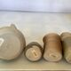 Seven beige and gray ceramic vases