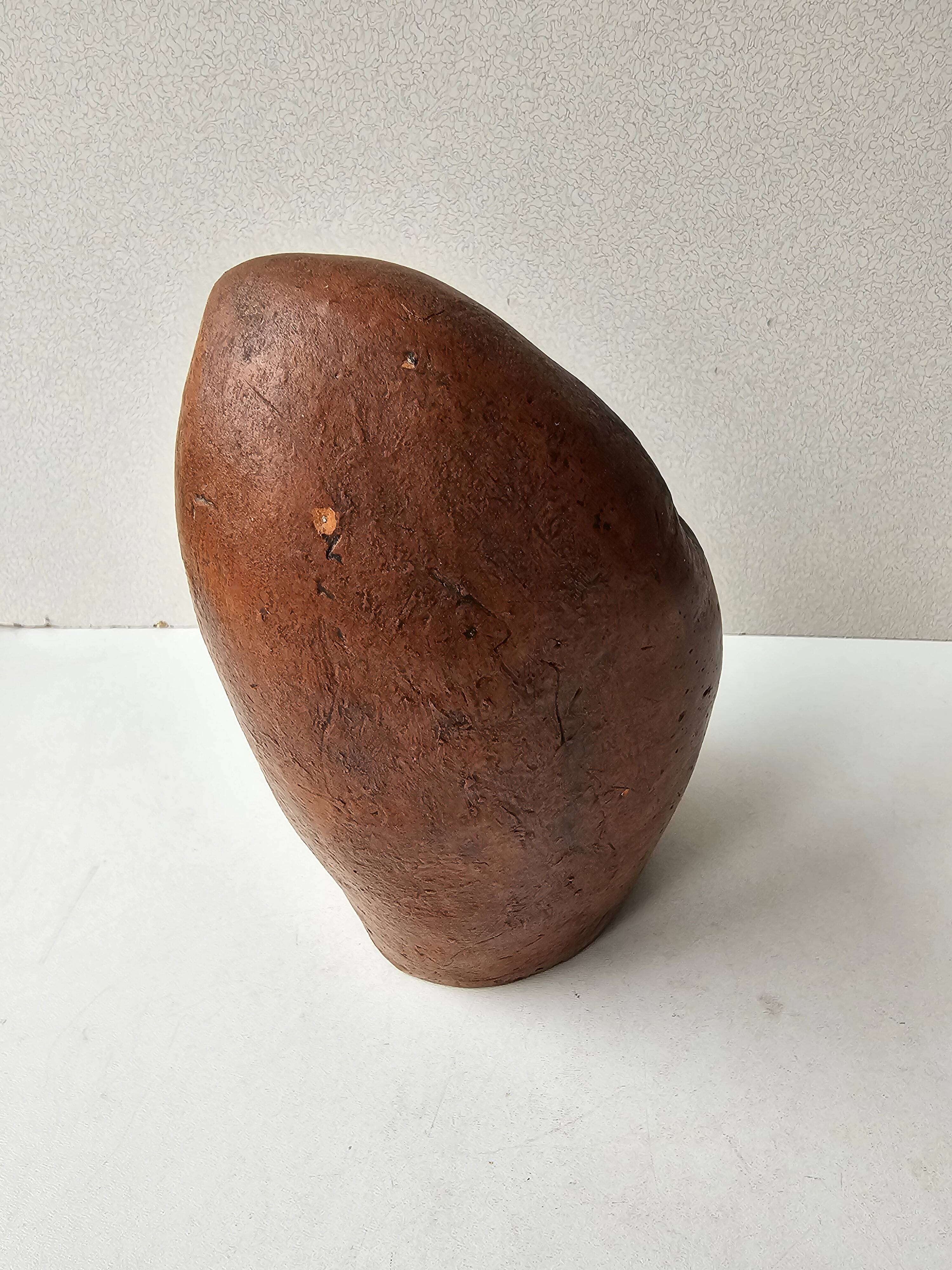 Terracotta face sculpture in African art style