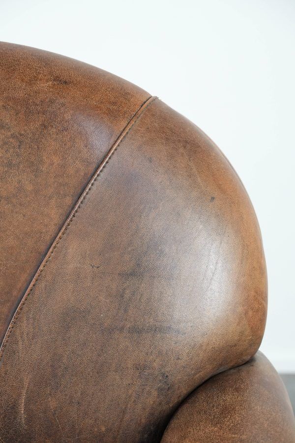 Beautiful vintage sheep leather armchair with a characterful appearance