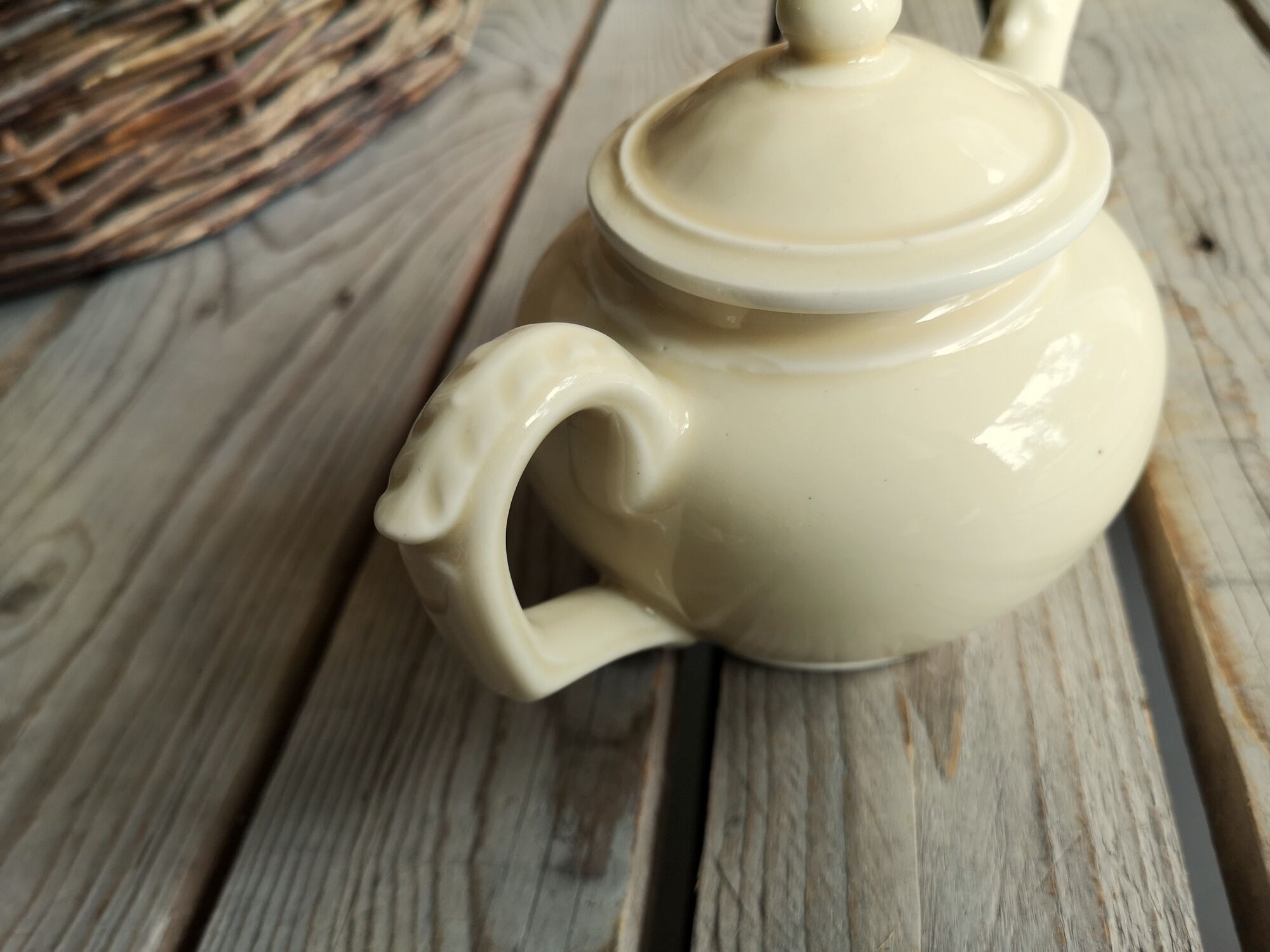 Little ancient teapot in ceramics color cream