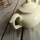 Little ancient teapot in ceramics color cream