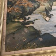 Old painting with a polychrome print decoration of ducks in nature.