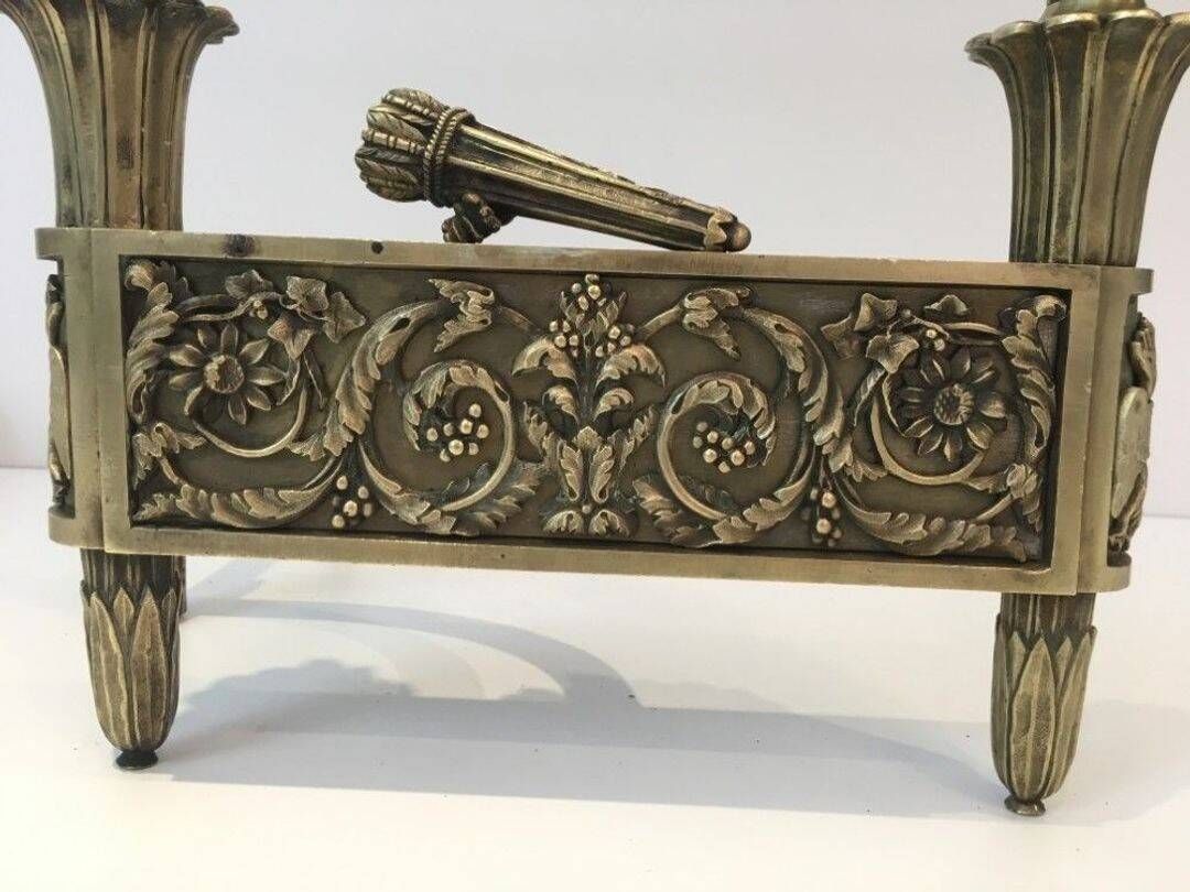 Pair of Empire Period Chenets in Chiselled Bronze with Torches and Leaf Frieze