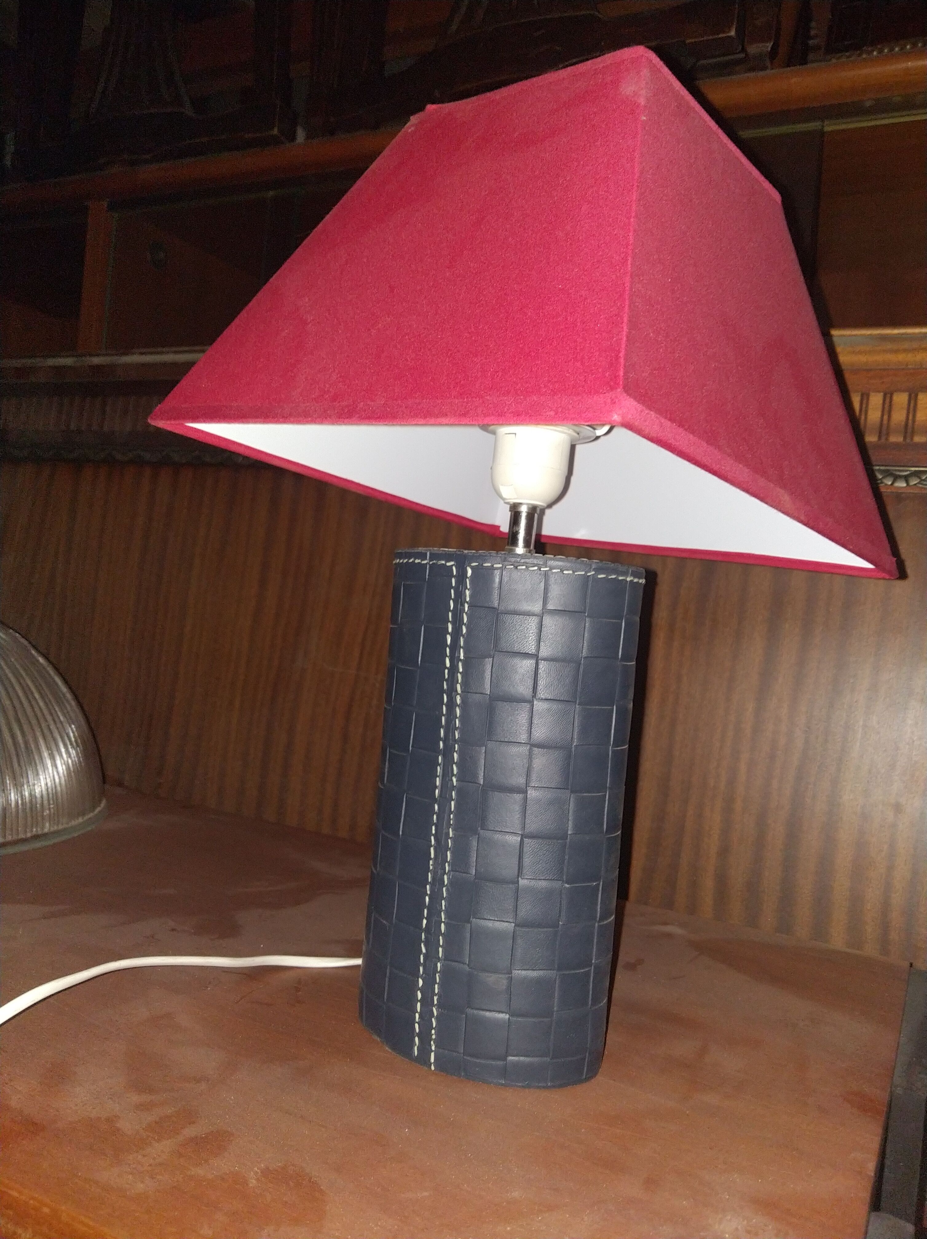 Ovoid lamp sheathed in braided blue leather and saddle stitching