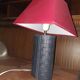 Ovoid lamp sheathed in braided blue leather and saddle stitching