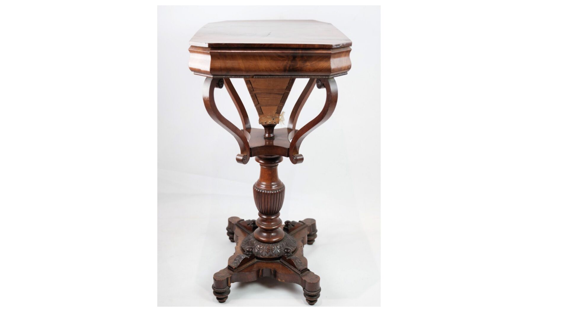 Antique mahogany sewing table on a pillar from around the year 1840s
