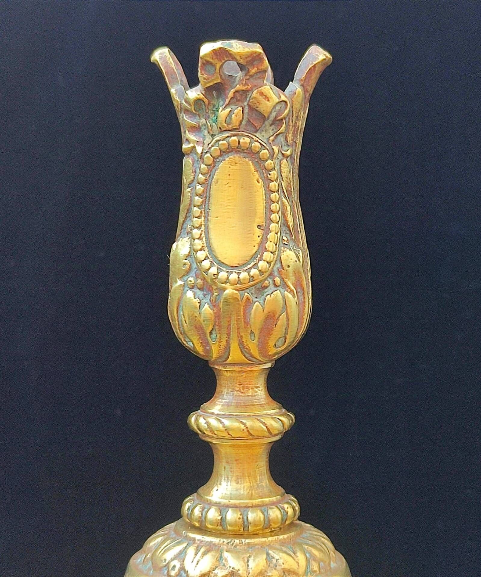 Pair of antique carved bronze candlesticks.
