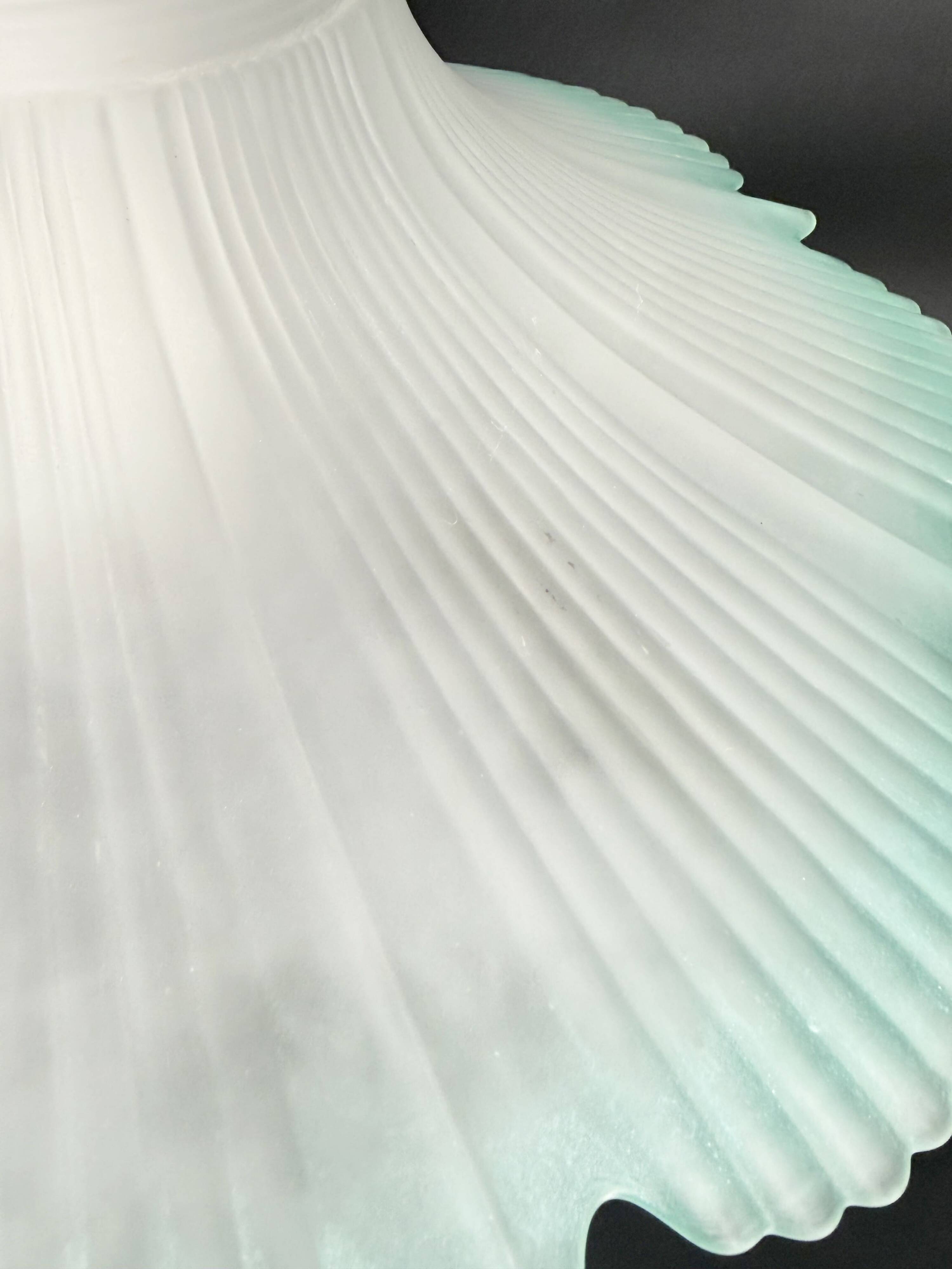 Frosted glass flower pendant with a water green edge.