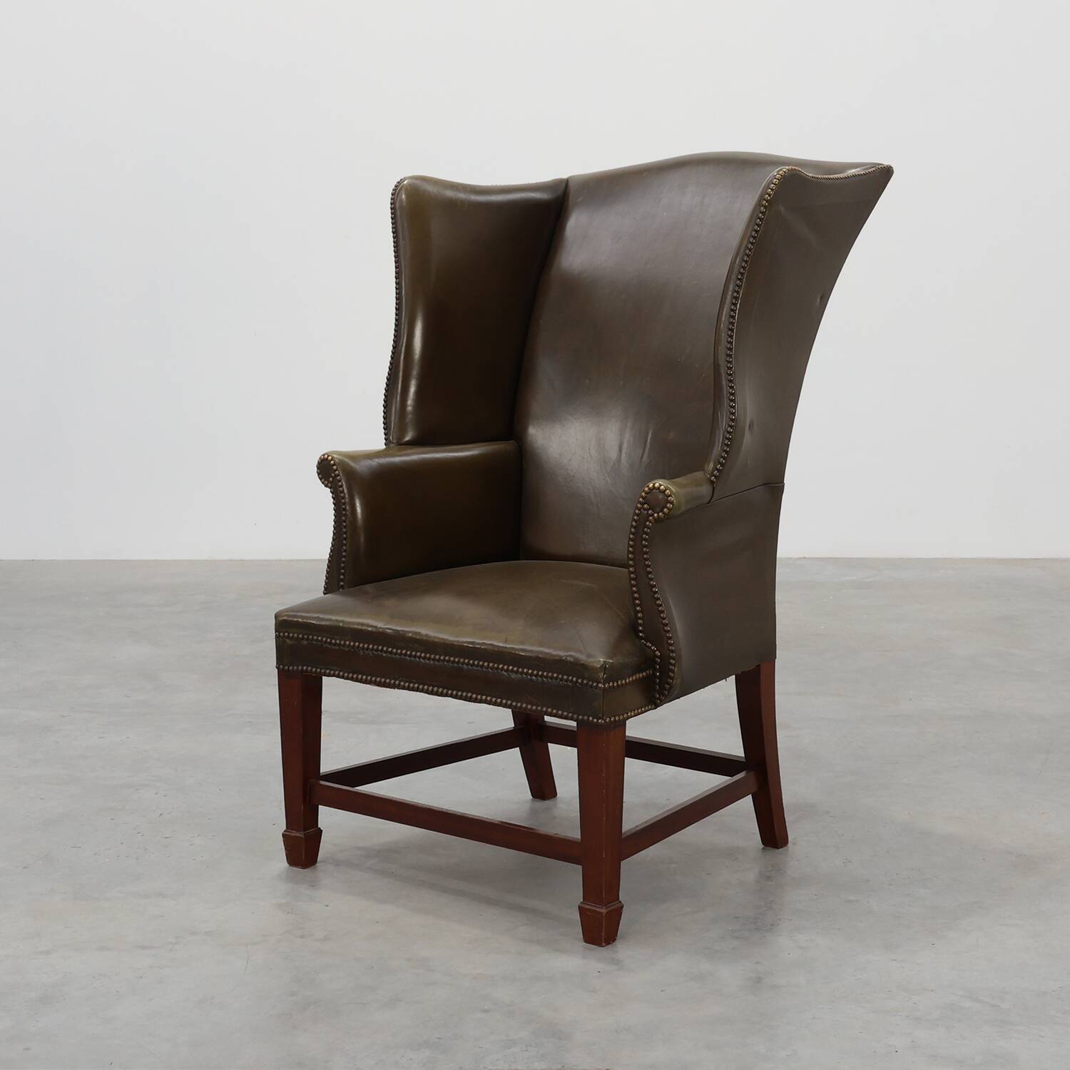 Mid-century Wing Back Armchair in green leather, UK