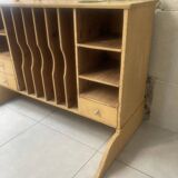 On a piece of furniture with sorting lockers and drawers