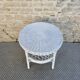 Round white rattan side table with storage underneath, circa 1970.