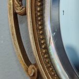 Antique hand-facing mirror in bronze and beveled glass