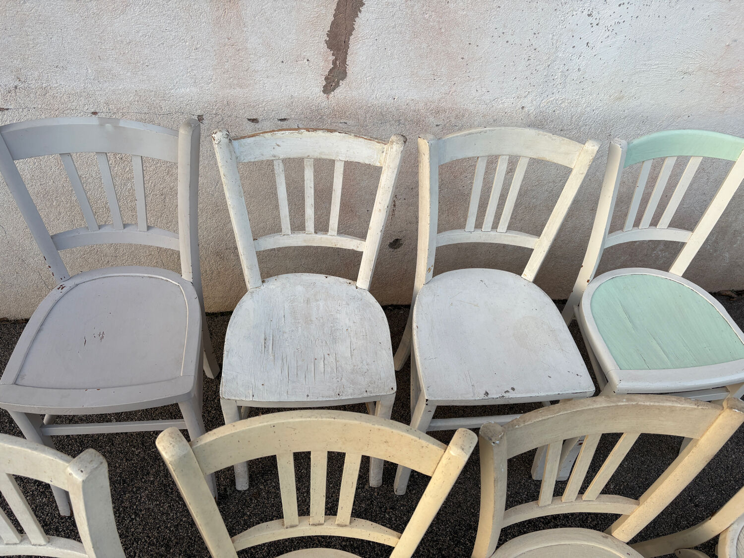 Set of 8 mismatched white bistro chairs