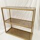 Golden metal shelf and smoked glass
