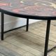 Vintage round coffee table in graphic red and yellow ceramic from the 1960s.