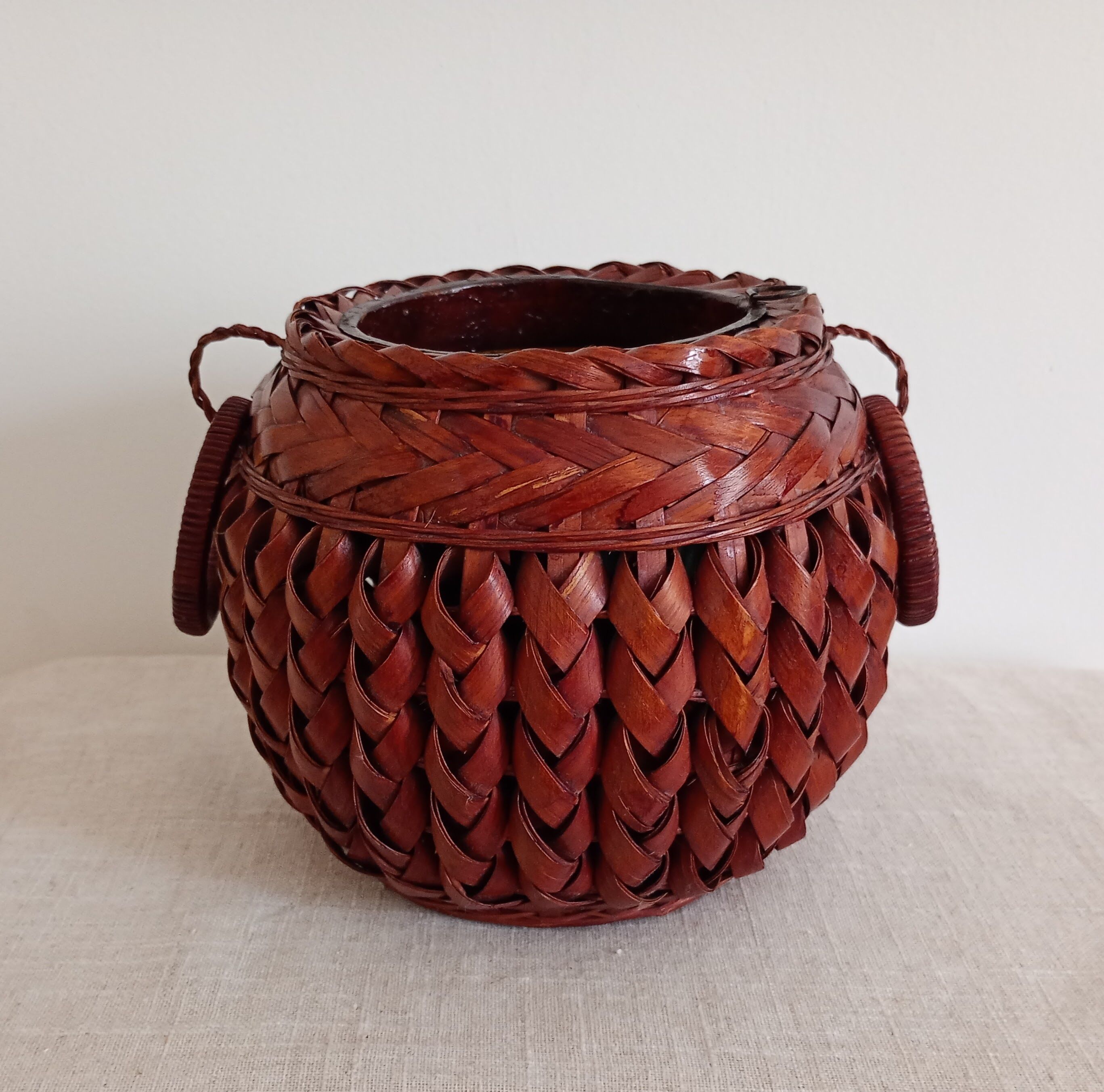 Japanese vase made of woven bamboo. Ikebana.