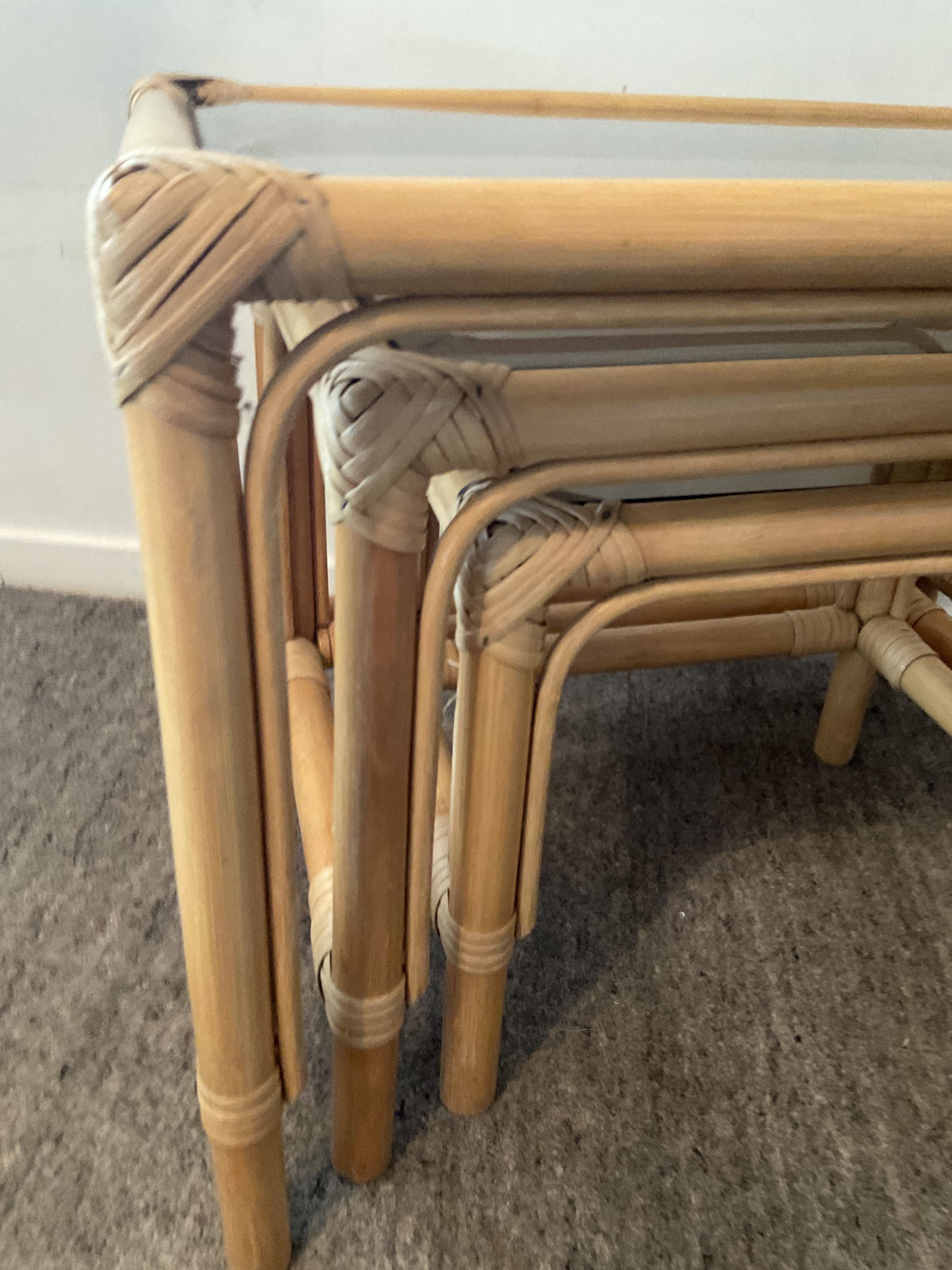 Trio of vintage pull-out tables in rattan and smoked glass 70s